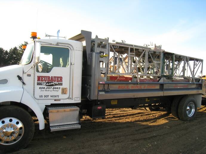 Neubauer Masonry Freightliner flatbed truck with scaffolding